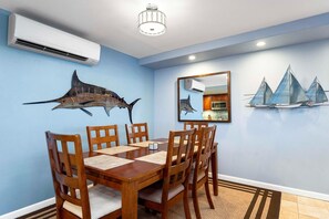 Dining area with split AC and table for six.
