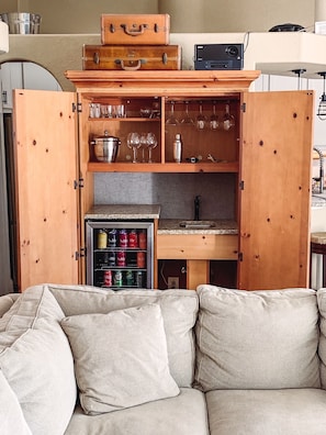 Living room also features fun "barmoire" equipped with sink & mini fridge