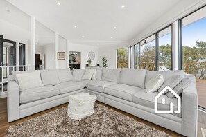 Comfy large modular couch in main living area, with Smart TV