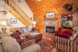 Living Room with Stone Fireplace and Flat Screen TV