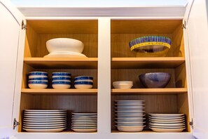 A stocked kitchen with plenty of dishes...