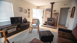 Comfy living room with TV and woodstove