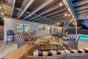 Covered patio with BBQ grill and heated pool