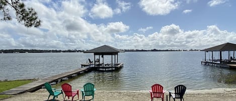 Private Sandy Beach with lots of extra chairs in the Garage.