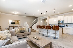 Stunning living area of the townhouse in Kissimmee, Florida - Comfortable seating with open kitchen and breakfast bar -  living room provides an ideal setting to come together and exchange stories