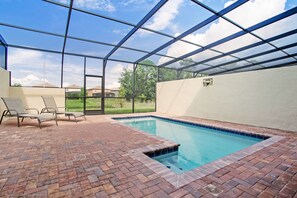 Private pool of the townhouse in Kissimmee, Florida - Unparalleled privacy as you swim beneath the stars in your exclusive glass-covered pool - Relax, unwind, and soak up the sun in style