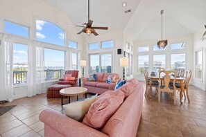 The top level great room is full of windows, almost floor to ceiling allowing lots of beautiful sunlight into the home as well as breathtaking views from the kitchen, dining and living areas.
