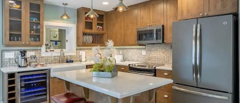 Fully equipped kitchen with island seating and dual-temp wine cooler