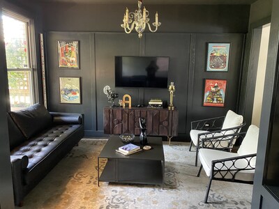 Lounge area with wood paneled walls. We call it “The Cube”. 