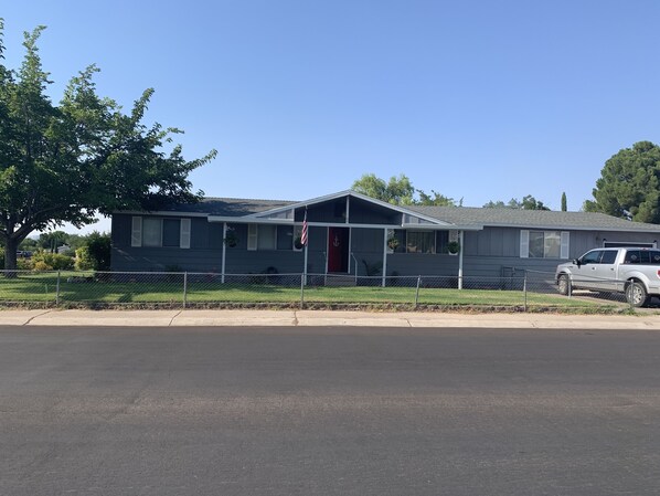 Fenced front yard with plenty of room for vehicle, boat and trailer parking