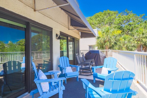 Step out onto the partially-covered second floor balcony to find this spacious seating area and gas grill.