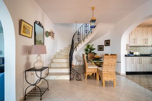 Spacious open plan living with sweeping marble staircase