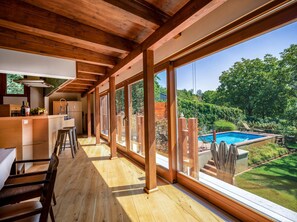 Wall to wall glass provides connection to the secluded garden and pool.