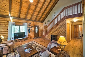 Stairs lead to the upper level, where a bedroom & loft overlook await.