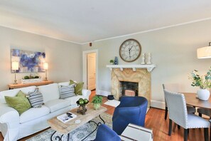 Relax in the living room with friends and family, table for games to the right and the front door to the stoop to the left of the picture!