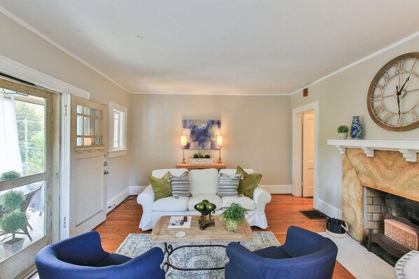 The living room is at the front of the property.  The front stoop is to the left of the picture, the upper right is going to the bed