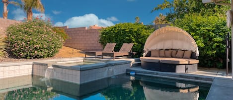 Saltwater pool, and hot tub with two lounge chairs and outdoor cabana lounge