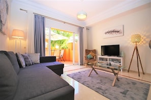 Bright and modern lounge with comfortable seating, air conditioning and international TV