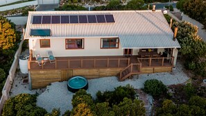 Covered stoep and large deck, solar panels provide renewable power and hot water