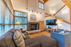 Living area featuring a gas fire place, mounted TV, and cozy furnishings.