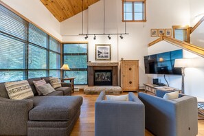 Living area featuring a gas fire place, mounted TV, and cozy furnishings.