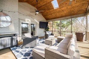 Outdoor living space with 65" Smart TV. 