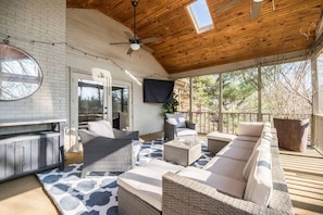 Outdoor living space with 65" Smart TV. 