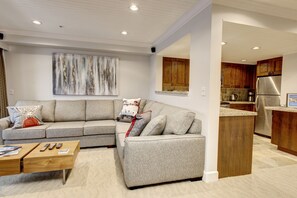  Living room with ample seating looking into the open plan Kitchen