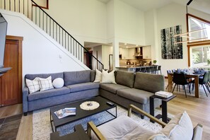 Open concept living space with Q sectional sleeper sofa looking into dining room