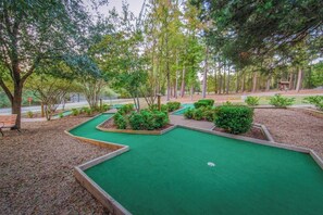 Enjoy a game of putt-putt just steps from the playground! This charming mini-golf course is surrounded by lush greenery, making it a perfect spot for family fun and friendly competition in a scenic setting.