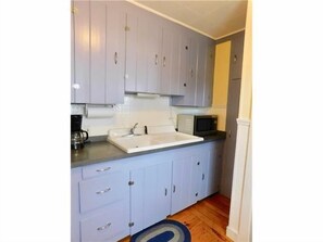 Cottage style Kitchen | Coffee Pot | Microwave | Stove | Retro sink | Refrigerator not shown