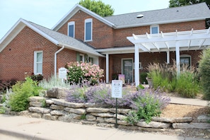 You are welcomed by a spacious patio surrounded by beautiful landscaping.
