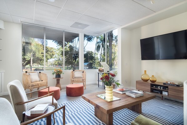 Spacious living room with views of the park.