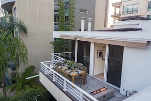 Upstairs patio has a fire pit to warm up your evenings.
