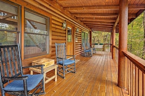 Full length front porch with rocking chairs and swing