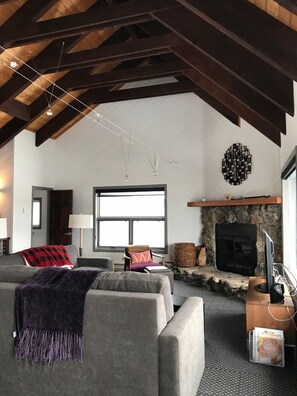 Living room with plenty of seating for all, fireplace and vaulted ceilings