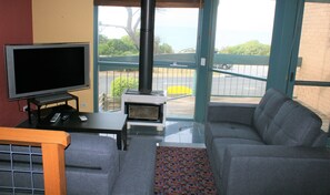 Lounge room with TV and set top box: overlooks balcony with great views of bay!