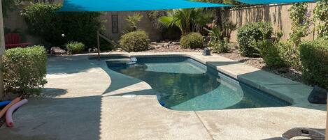 2 shade sails over the pool during the summer