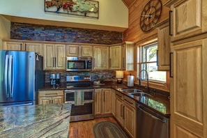 Large kitchen with high end appliances and granite
