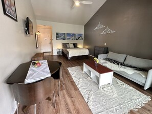 The hardwood floors add to the modern look of the Park City rental condo. The dining table is a drop-leaf table. It saves space and you can make it larger if you need more table space. 