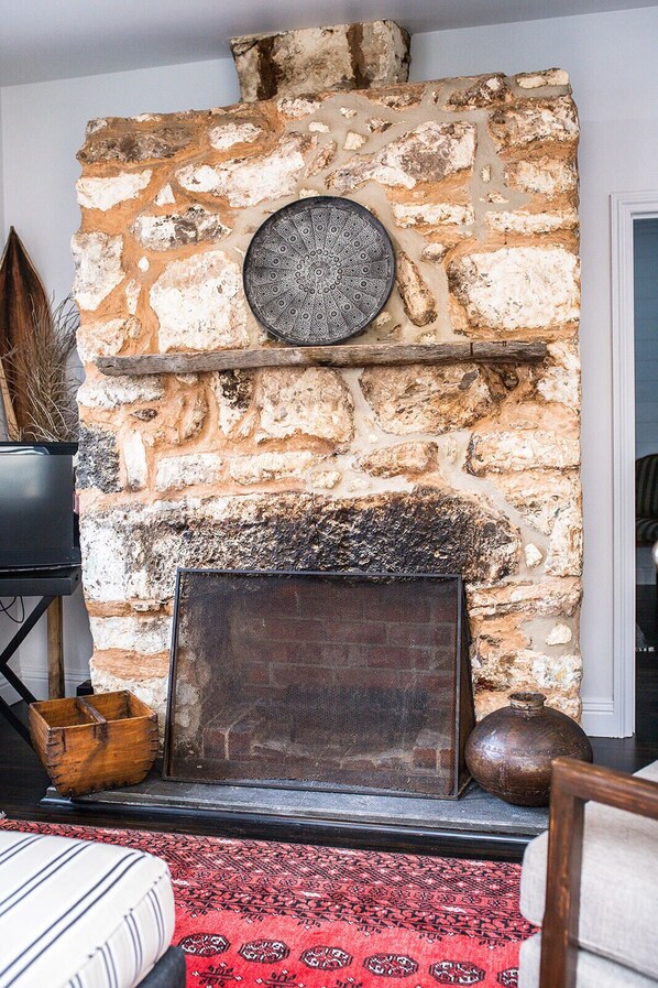 Stunning stone fireplace ideal for winter getaways.