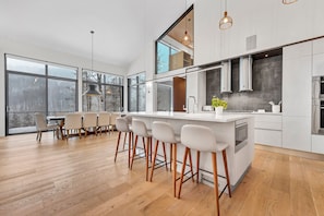 Kitchen with views of slopes, seating for 6 at island.