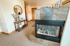 The 3-sided gas fireplace offers cozy ambiance throughout the condo