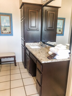 Master bathroom has double vanities, and a shower. 
