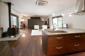 A living room with an island type kitchen