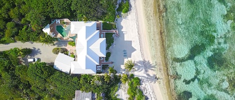 Aerial view of Hilltime's wide beachfront with backyard snorkeling. 