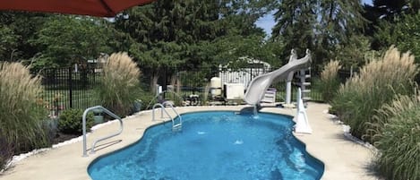 Private heated salt water pool with water slide. Open late April to late October