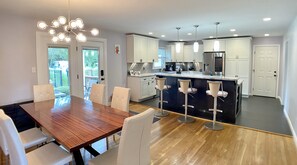 Open concept: Kitchen w/island (seats 3 at bar top) and dining table (seats 6)