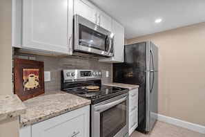 Kitchen with full dish set, pots and pans, and everything you need for cooking 