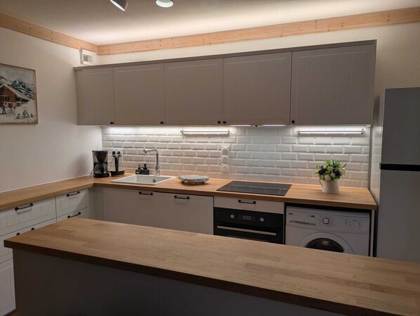 Newly renovated kitchen with full size refrigerator 
